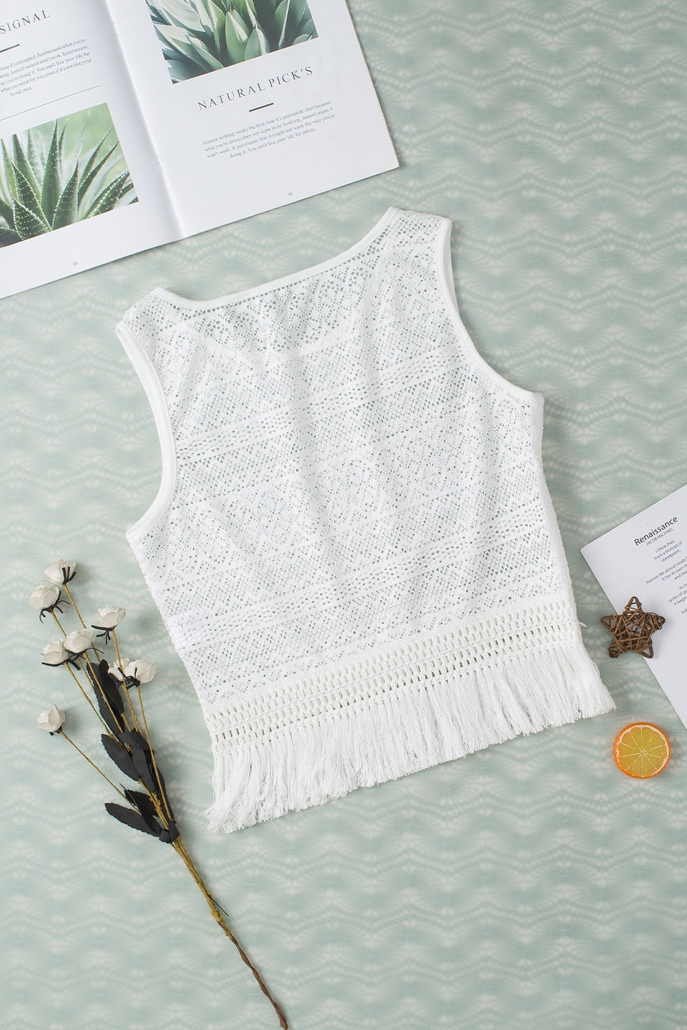 "Woman wearing a fringe tank top with tassel hem, ideal for festival outfits and casual boho style"
