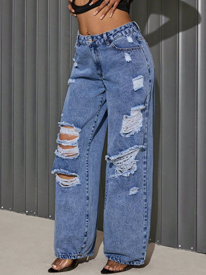 "She Wild Distressed Wide-Leg Jeans – High-waisted, edgy denim with bold distressing and a statement wide-leg fit for a fearless look."